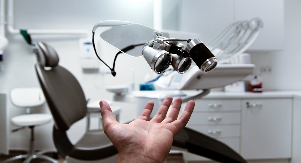 Services-02 Floating dental loupes in a modern, clean dentist office setting.